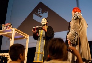 A Kopimist marriage. Not sure why the priest is dressed like V for Vendetta.