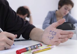 boy_cheating_on_math_test_42-17681679